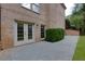 Exterior view of home with brick, a concrete patio and a manicured lawn at 360 Hannaford Dr, Roswell, GA 30075