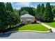 Traditional brick home with a well-maintained lawn and mature trees surrounding the property at 360 Hannaford Dr, Roswell, GA 30075