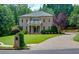 Beautiful two-story brick home with manicured lawn and circular driveway at 360 Hannaford Dr, Roswell, GA 30075