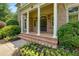 Elegant front porch with classic columns and a beautiful flower garden at 360 Hannaford Dr, Roswell, GA 30075