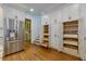 Stainless steel fridge next to a wall of cabinets with pull out drawers at 360 Hannaford Dr, Roswell, GA 30075