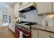 Stylish kitchen with stainless steel range and pot filler faucet at 360 Hannaford Dr, Roswell, GA 30075