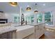 Kitchen island with granite counters, sink, and an open view to the living room at 360 Hannaford Dr, Roswell, GA 30075