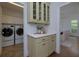 Butler's pantry featuring counter space, cabinets, and view to laundry and dining rooms at 360 Hannaford Dr, Roswell, GA 30075