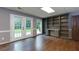 Spacious finished basement living room with hardwood floors, built-in shelving and walk out access at 360 Hannaford Dr, Roswell, GA 30075