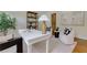 Well-lit office featuring a large desk, bookshelves, and stylish decor at 360 Hannaford Dr, Roswell, GA 30075
