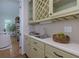 An elegant wet bar features cream cabinets, white countertops, and a wine rack at 360 Hannaford Dr, Roswell, GA 30075