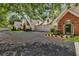 Lovely home showcasing the attached garages and meticulous landscaping and driveway at 1249 Creek Forest Ln # Bldg 8, Austell, GA 30106