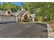 Home featuring attached garage, mature trees and a paved driveway at 1249 Creek Forest Ln # Bldg 8, Austell, GA 30106