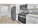 Modern kitchen boasting stainless steel appliances and sleek white cabinets at 1249 Creek Forest Ln # Bldg 8, Austell, GA 30106