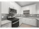 Modern kitchen featuring stainless steel appliances, gray backsplash, and granite countertops at 1249 Creek Forest Ln # Bldg 8, Austell, GA 30106