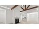Bright living room featuring wooden beams, vaulted ceiling, and a cozy fireplace at 1249 Creek Forest Ln # Bldg 8, Austell, GA 30106