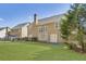Large backyard with lush green grass, a patio, and a view of the home's rear elevation at 173 Northshore Xing, Dallas, GA 30157