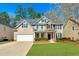 Charming two-story home with a well-manicured lawn, attached garage, and a welcoming entrance at 173 Northshore Xing, Dallas, GA 30157