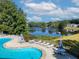 Community pool area overlooking the lake, complete with lounge chairs and tables at 173 Northshore Xing, Dallas, GA 30157