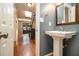 Stylish bathroom with a pedestal sink, hardwood floors, and modern fixtures at 186 Fernleaf Lane Ln, Marietta, GA 30068