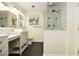 Bright bathroom features double sinks with white cabinetry, stylish mirrors and a walk-in shower at 186 Fernleaf Lane Ln, Marietta, GA 30068