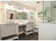 Bright bathroom features double sinks with white cabinetry and a walk-in shower at 186 Fernleaf Lane Ln, Marietta, GA 30068