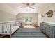 Bedroom features wood floors, ceiling fan and a crib with a colorful rug at 186 Fernleaf Lane Ln, Marietta, GA 30068