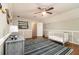 Bedroom features wood floors, ceiling fan and a crib with a blue striped rug at 186 Fernleaf Lane Ln, Marietta, GA 30068