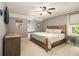 Bright bedroom features neutral walls, ceiling fan, window seat and wooden bed frame at 186 Fernleaf Lane Ln, Marietta, GA 30068