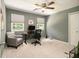 Bedroom features neutral walls, carpet, ceiling fan, gray chair and computer desk at 186 Fernleaf Lane Ln, Marietta, GA 30068