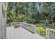 Outdoor deck overlooking a private backyard with mature trees and a playset at 186 Fernleaf Lane Ln, Marietta, GA 30068