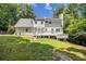 Backyard view of home with deck, yard, and mature trees at 186 Fernleaf Lane Ln, Marietta, GA 30068