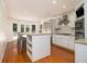 Open kitchen with white cabinets, stainless steel appliances, and a breakfast bar island at 186 Fernleaf Lane Ln, Marietta, GA 30068