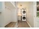 Convenient laundry area with stacked washer and dryer units and built-in cabinetry at 186 Fernleaf Lane Ln, Marietta, GA 30068