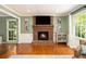 Charming living room featuring a brick fireplace, hardwood floors, and large windows at 186 Fernleaf Lane Ln, Marietta, GA 30068