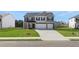 Charming two-story home featuring a well-manicured lawn, a paved driveway, and a two car garage at 1900 Van Allen Ct, Dacula, GA 30019