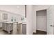 Bright eat-in kitchen features an island, stainless appliances, granite counters, and grey cabinets at 1900 Van Allen Ct, Dacula, GA 30019