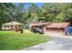 Spacious backyard with separate cottage and an adjacent car in the driveway at 2247 Cypress Ave, Morrow, GA 30260
