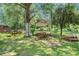 Lush backyard featuring a gazebo, picnic tables, bench seating, and mature trees for shade at 2247 Cypress Ave, Morrow, GA 30260