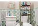 A full bathroom features tiled walls and floors, a white toilet, a vanity, and a built-in shower at 2247 Cypress Ave, Morrow, GA 30260