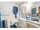 A bright bathroom features tiled walls and floors, a white toilet, a vanity, and a blue shower curtain at 2247 Cypress Ave, Morrow, GA 30260