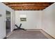 Unfinished room with exposed ceiling beams and small window at 2247 Cypress Ave, Morrow, GA 30260