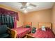 A bedroom features two single beds with matching headboards, a ceiling fan, and hardwood floors at 2247 Cypress Ave, Morrow, GA 30260