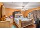 A spacious bedroom has hardwood floors, a ceiling fan, and is furnished with a queen bed and dresser at 2247 Cypress Ave, Morrow, GA 30260