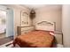 Bedroom with a floral bedspread, dresser, and vanity with an ornate headboard at 2247 Cypress Ave, Morrow, GA 30260