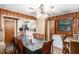 Traditional dining room with wood paneled walls and a ceiling fan at 2247 Cypress Ave, Morrow, GA 30260