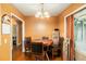 A cozy dining area features a round wooden table, matching chairs, and a decorative chandelier for intimate gatherings at 2247 Cypress Ave, Morrow, GA 30260