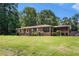 A ranch home with well-maintained front yard and a screened porch, creating a welcoming curb appeal at 2247 Cypress Ave, Morrow, GA 30260