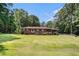 Traditional home boasting a lush, green lawn and mature trees, creating a serene outdoor setting at 2247 Cypress Ave, Morrow, GA 30260