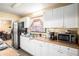 Functional kitchen with white cabinets, stainless steel appliances, and ample counter space at 2247 Cypress Ave, Morrow, GA 30260