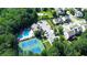 Community amenities including a pool, tennis courts, clubhouse, and parking area nestled in lush greenery at 2423 Walnut Tree Ln, Buford, GA 30519