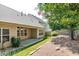 View of the backyard featuring a covered porch and well-maintained landscaping at 2423 Walnut Tree Ln, Buford, GA 30519