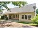 View of the backyard featuring a covered porch and well-maintained landscaping at 2423 Walnut Tree Ln, Buford, GA 30519