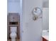 Bathroom with toilet, cabinet, and a vanity mirror, offering convenience and functionality at 2423 Walnut Tree Ln, Buford, GA 30519